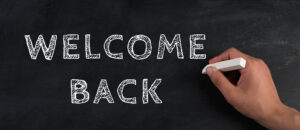 The Words Welcome Back Are Standing On A Chalkboard, Reopen Post Covid 19 Pandemic, Back To Normal, Community